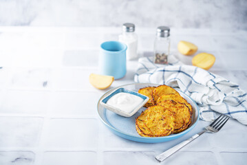 Potato hash browns with sour cream sauce in a plate
