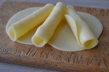 Sliced Cheese on wooden background