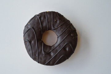 Delicious donut topped with chocolate on a white background