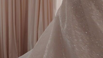 Elegant happy bride wearing shiny wedding dress with loose skirt spins around in room closeup slow motion. Fashion and marriage ceremony. Holiday event - Powered by Adobe