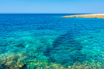 Amazing crystal clear water in the beach of Porto Selvaggio Natural Reserve in Salento, Apulia Italy