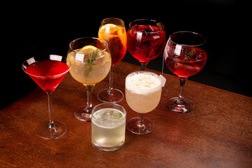 mixology mix assorted and colorful cocktails collection on corner wooden table angle view