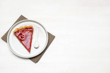 Delicious red cherry strawberry tart and crumble cake with oat.serving of gourmet confection dessert topped on plate.Piece of sweet tasty pastry baked pie cheesecake with ripe berries on wooden table