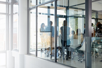 It all begins in the boardroom. Full length shot of a business meeting taking place in a glass-walled boardroom.