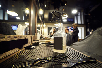 Salon. Man in a barber chair. The hairdresser serves the client in the barbershop. The concept of male cosmetology.