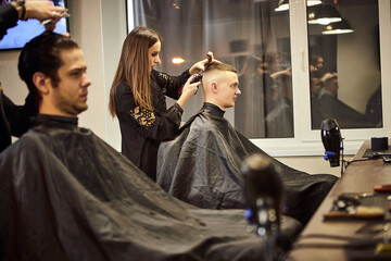 Salon. Man in a barber chair. The hairdresser serves the client in the barbershop. The concept of male cosmetology.