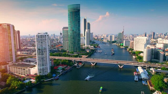 4K UHD : Bangkok River drone view. Flying over the Chao Phraya River, the main river of Thailand. Boat traffic and buildings around the river. beautiful morning
