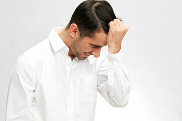 businessman portrait in a white shirt holding on to hair a pensive look self-confidence elegant style
