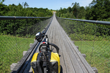 bicycle with panniers on suspension bridge