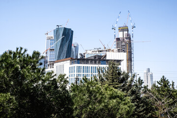Fototapeta na wymiar Istanbul, Turkey - April 2022: Towers under construction. Tower cranes and construction. Istanbul Finance Center tower structures. Selective focus.