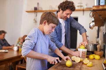Making lemonade for the family. A cropped portrait of a happy father and son making lemonade in their kitchen at home. - obrazy, fototapety, plakaty