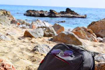 glasses in a backpack on the beach