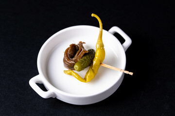 Typical appetiser in Basque country  "gilda" made of spicy pepper, pickled cucumber and anchovy.