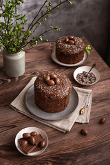 Easter cake:  traditional Russian Easter yeast pastry  Kulich - chocolate cake with raisins and chocolate icing on a dark wooden table