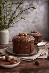 Easter cake:  traditional Russian Easter yeast pastry  Kulich - chocolate cake with raisins and chocolate icing on a dark wooden table
