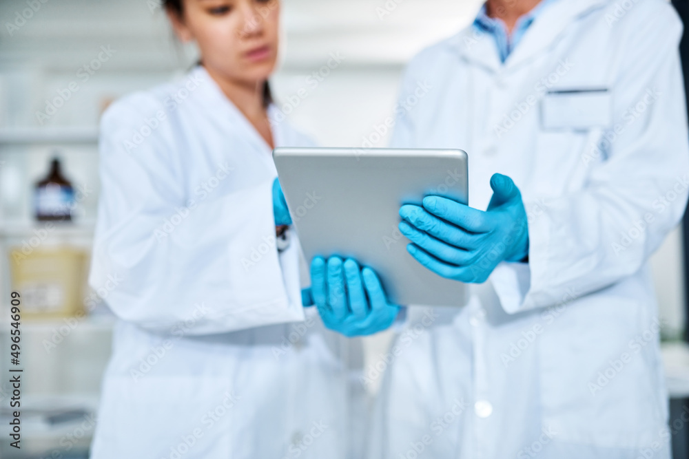 Aufkleber .Without science there can be no knowledge generation. Closeup shot of two scientists working together on a digital tablet in a lab.