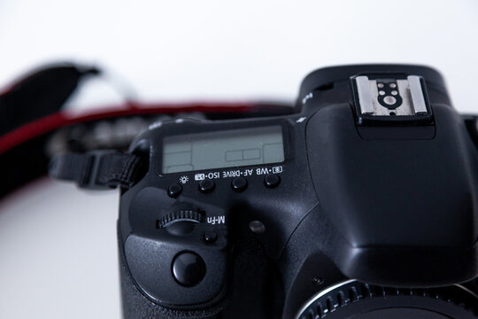 DSLR camera body in black color on white background. DSLR camera with battery grip attached.