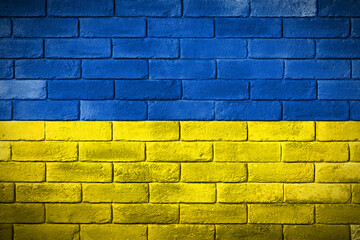 Flaga Ukrainy namalowana na ceglanym murze. The flag of Ukraine painted on a brick wall.