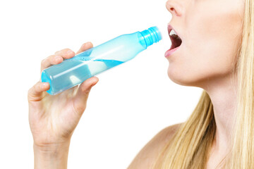 Smiling woman holding bottle of liquid cosmetic, having fun, enjoying morning routine procedure for skincare. Beauty therapy concept.