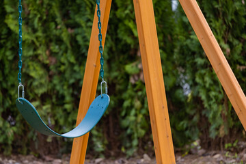 A swing set sitting there doing nothing, just dangling in the open air by itself.