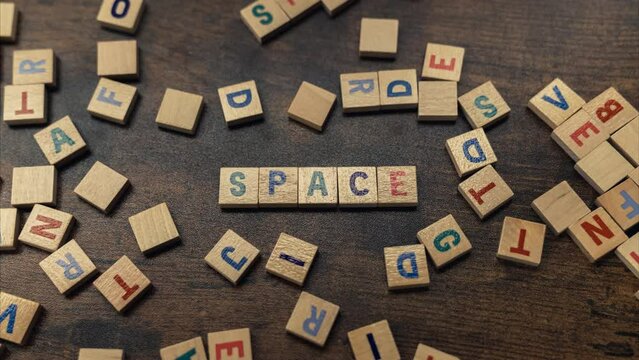 Zooming in the word SPACE made of wooden alphabetic blocks vocabulary game . High quality 4k footage