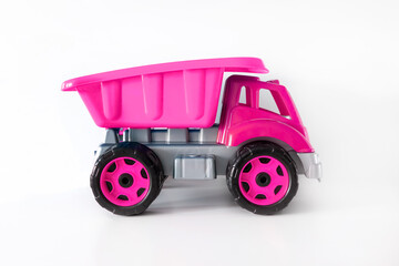 Colorful large pink plastic dump truck, tip lorry, car toy isolated on white background mockup with copy space, toys for children, girls, kids development, playing, childhood fun