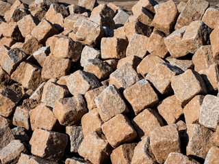 Cobblestones lie in a big heap. 
