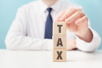 Concept of income tax with wooden blocks