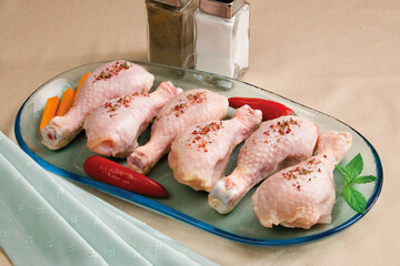 Raw organic chicken legs on table