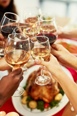 Wine pairs nicely with good friends. Cropped shot of a group of people making a toast at a dining...