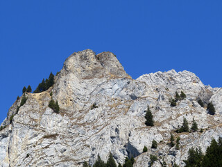 Rocky peak Dejenstogg or Dejenstock (2022 m) in the Glarus Alps mountain range, over the Klöntalersee (or Kloentalersee) reservoir lake and Klöntal alpine valley - Canton of Glarus, Switzerland
