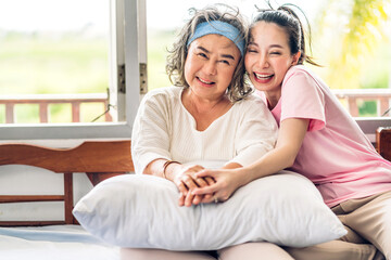 Obraz premium Portrait of enjoy happy love asian family senior mature mother and young woman daughter smiling laughing embracing and having fun hug together.happy family in moments good time at home