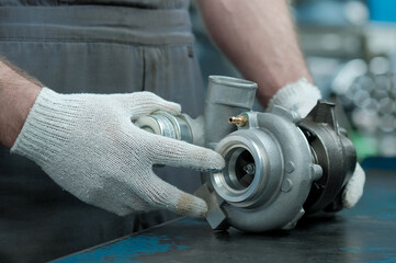 A turbine for an automobile engine on the desktop of an auto mechanic. Maintenance and repair of...