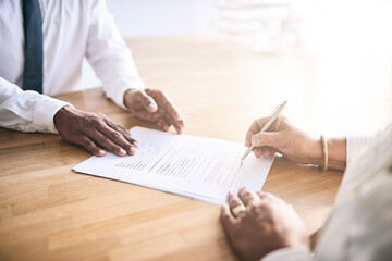 Just sign here and thats that. Shot of a unrecognizable business person signing a document.