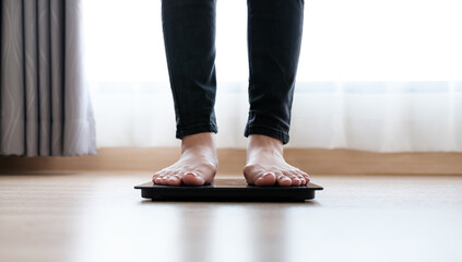 Woman's feet weighing on scales. weight loss, self care and body Concept.