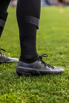 Close up view of a soccer (football) player's legs and cleats. Vertical Generic soccer or football photo