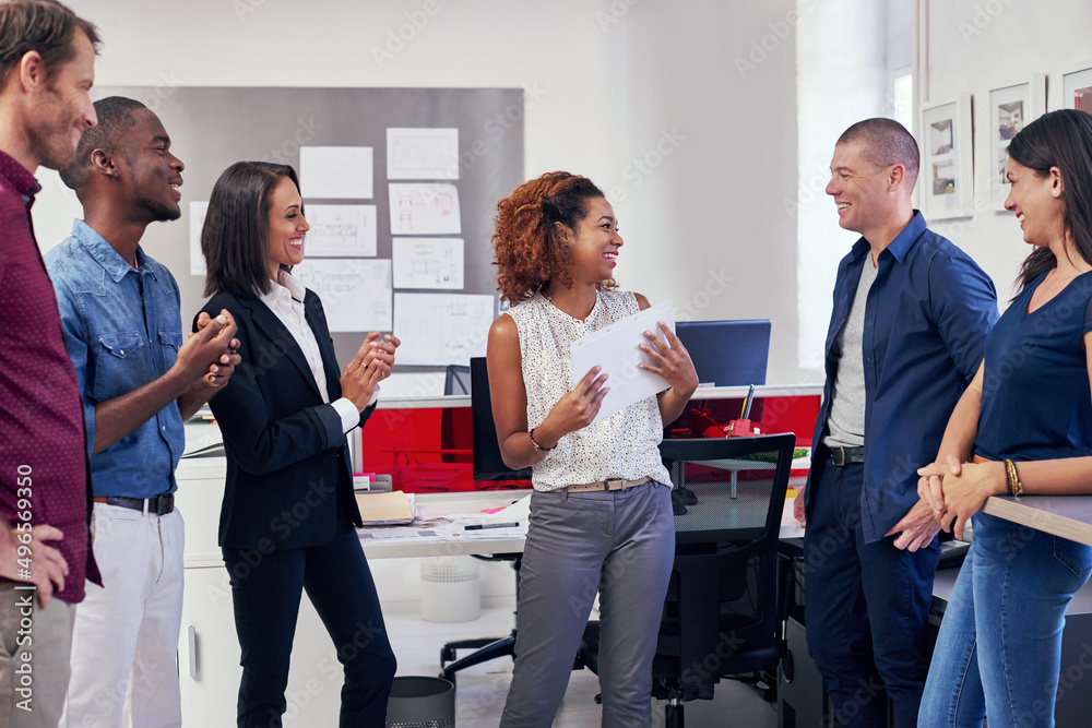 Poster coming up with some great ideas as a team. shot of a group of office workers in a meeting.