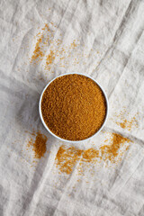 Brown Demerara Sugar in a Bowl, top view. Flat lay, overhead, from above.