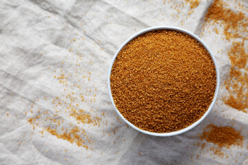 Brown Demerara Sugar in a Bowl, top view. Flat lay, overhead, from above. Copy space.