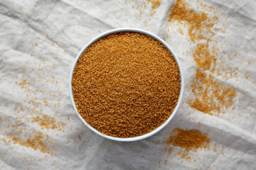 Brown Demerara Sugar in a Bowl, top view. Flat lay, overhead, from above.