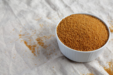 Brown Demerara Sugar in a Bowl, side view. Copy space.