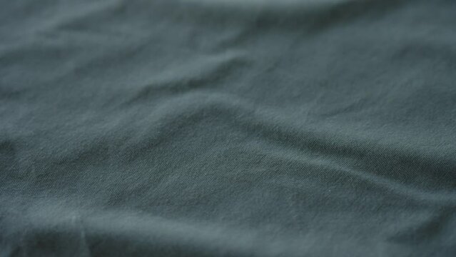 Slow motion handheld shot of blue cotton fabric