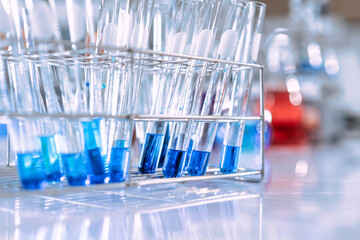 glass flask in chemical science education laboratory with molecular structure in blue background