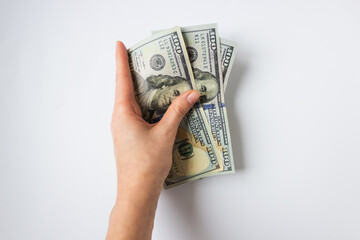 Woman's hand holds money 300 dollars for immigration on white background. Because of the war and...