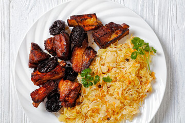 braised sauerkraut with pork and prunes on plate
