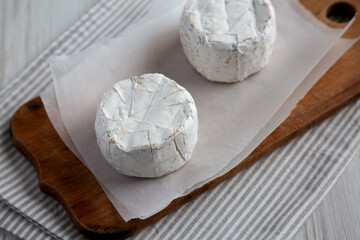 Alpine Blue Cheese on a rustic wooden board, side view.