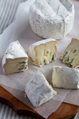 Alpine Blue Cheese on a rustic wooden board, low angle view.