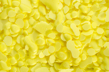 Pile of yellow sulfur granules used in medicine, fertilizers. Yellow sulfur background, texture,...