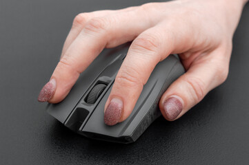 Hand holding computer mouse. Close up.
