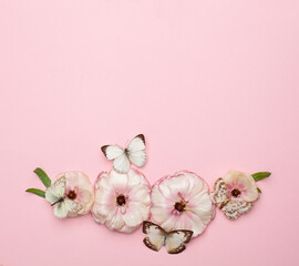 Fototapeta na wymiar Minimal pastel pink card background with beautiful spring flowers and butterflies